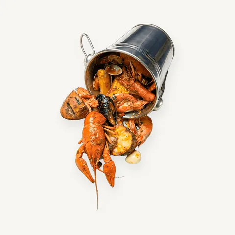 Kraken set: a bucket of crayfish, shrimp and mussels tipped onto a tray