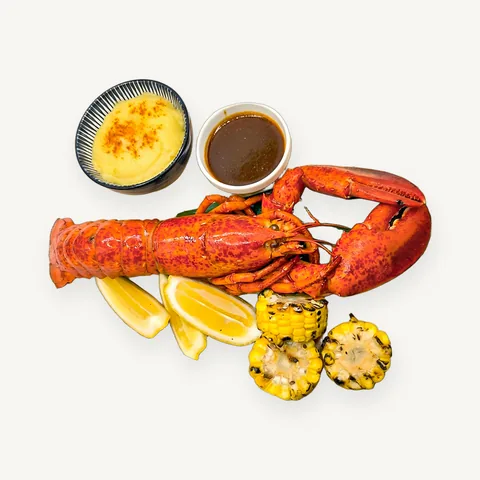 Whole lobster with lemon, grilled corn and two sauces