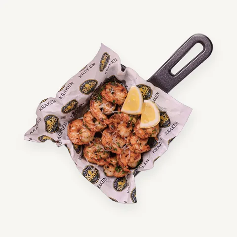 Pan-fried shrimp in a cast-iron skillet with lemon