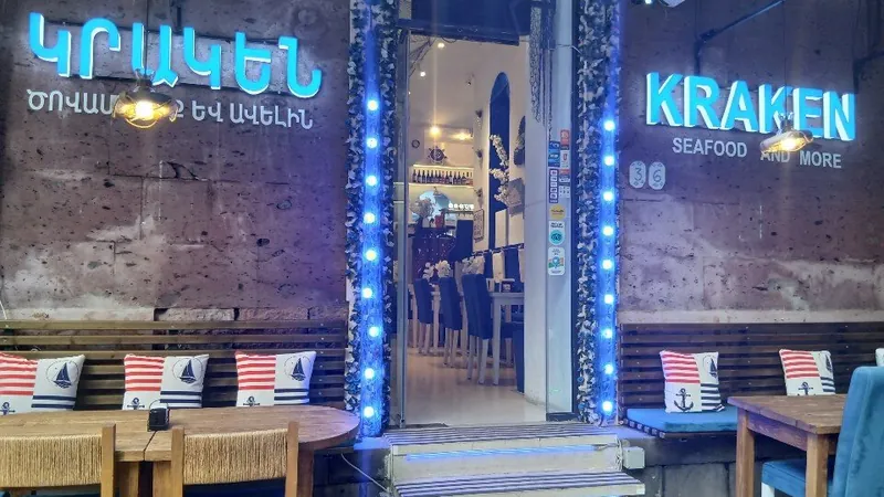 The front of Kraken: blue lights around the door, striped cushions on the terrace benches